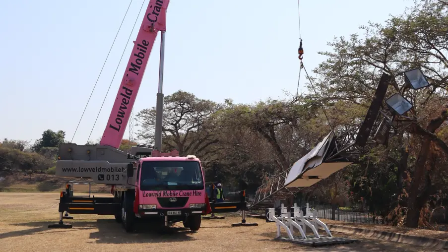 Picture of the Pink Lady crane lifting a stadium light