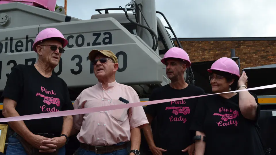 The family that owns Lowveld Mobile Crane Hire standing in front of the Pink Lady crane on the day of its launch