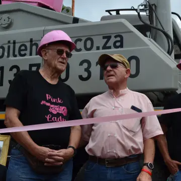 The family that owns Lowveld Mobile Crane Hire standing in front of the Pink Lady crane on the day of its launch