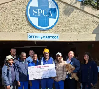 LMCH personnel with White River SPCA members as they recieve their donation of R5 000